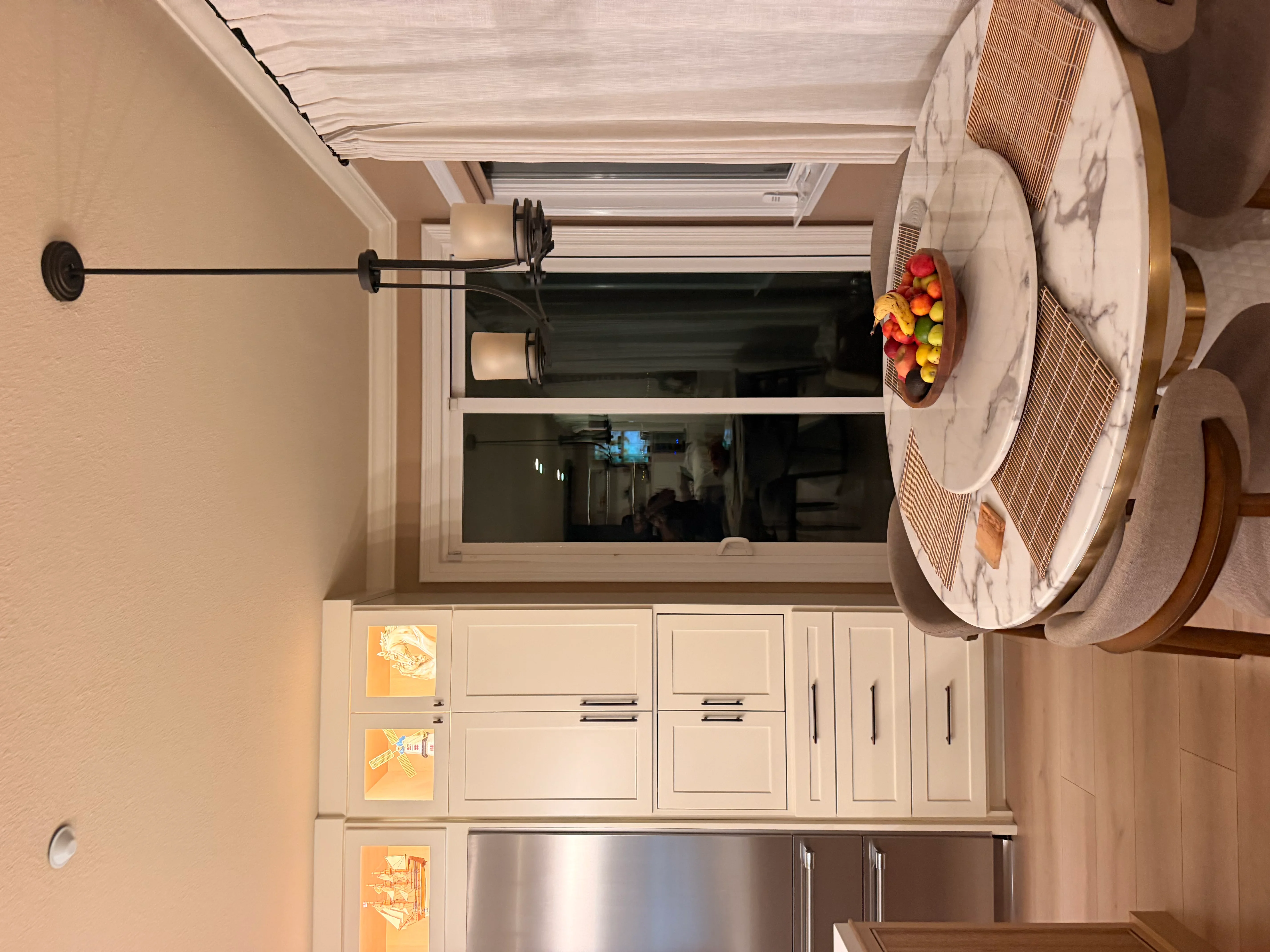 Kitchen with cream cabinetry, stainless steel appliances, large window, and recessed lighting