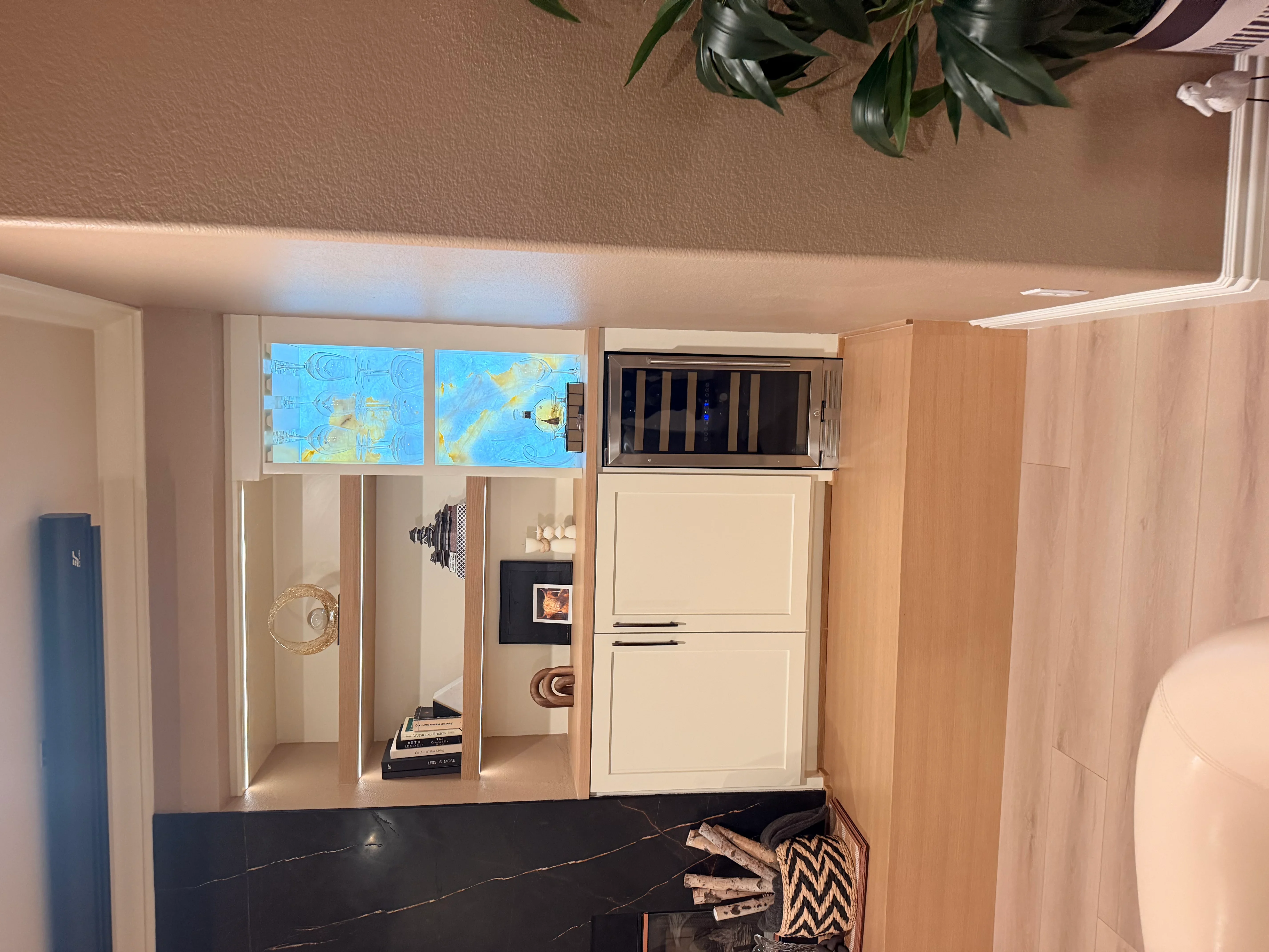 Custom wood kitchen cabinetry with integrated stainless steel appliances and open shelving
